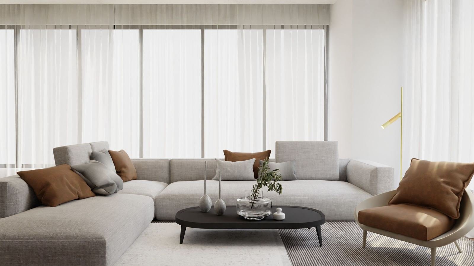 Sala de estar minimalista com sofá de canto cinzento e almofadas cor de caramelo
